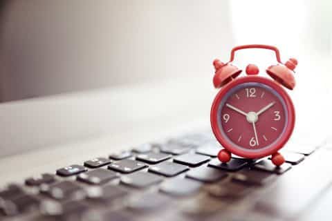 Alarm clock sits on keyboard.