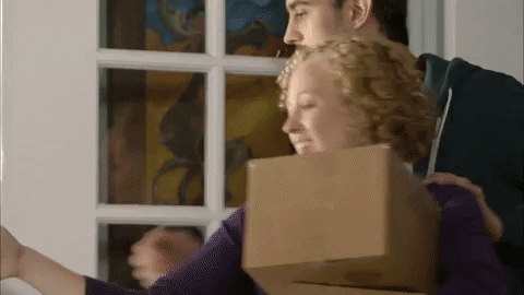 Man and woman happily grab delivery boxes. 