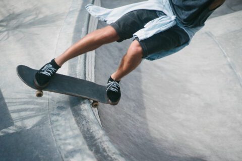 Waist-down image of a skateboarder on board doing tricks.