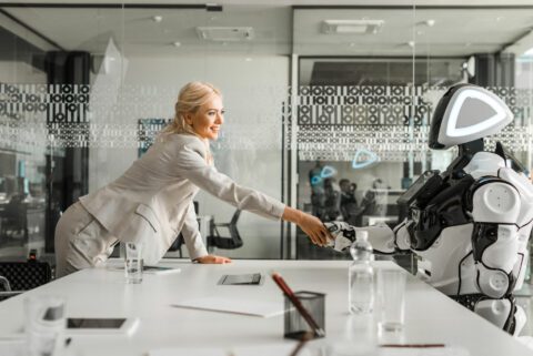 Woman shaking hands with a robot