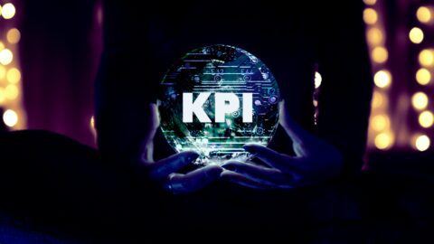 Woman holding a crystal ball with the letters “KPI” in the center