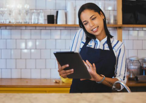 Woman in Apron Conducting Business On Her Phone