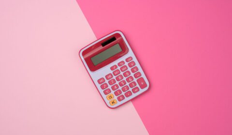 A pink calculator on a pink background