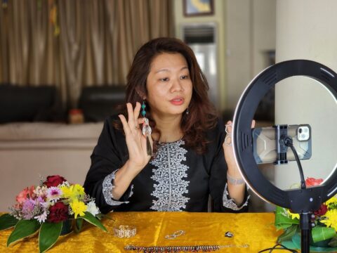 Woman recording video to establish her brand identity